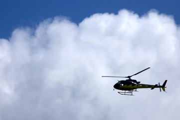 Fototapeta na wymiar Helicopter silhouette in a cloud