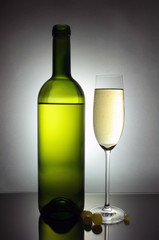 white wine glass and bottle
