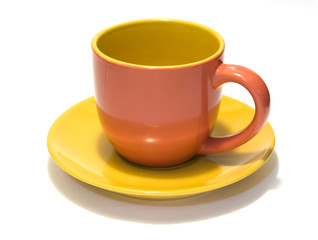 glazed pottery coffee cup and saucer with white background