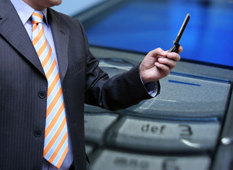Businessman sending a mms