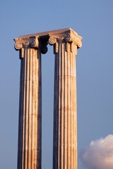 Two greek columns against blue sky