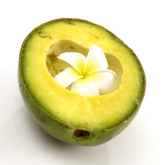 Half avocado isolated with tropical flower