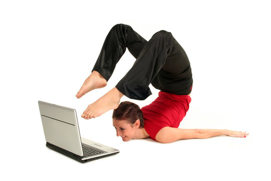 Woman doing yoga with laptop 