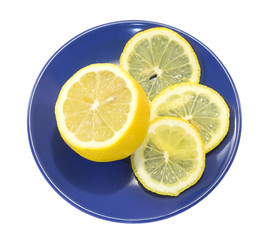 Sliced Lemon on a blue plate isolated on white background
