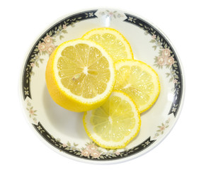 Sliced Lemon on a white plate isolated on white background