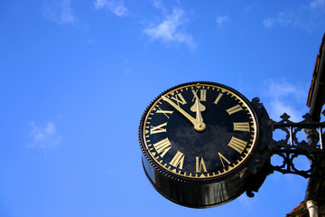 Large Public Clock Against Blue Sky