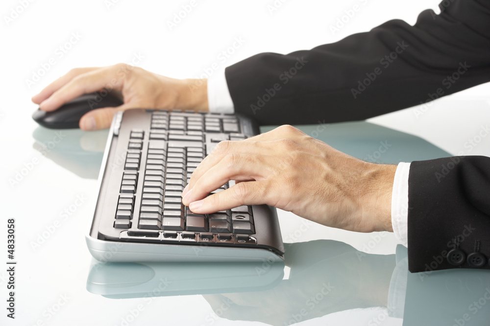 Wall mural male manager using wireless keyboard and mouse