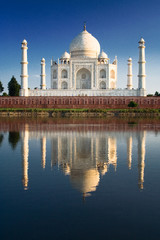 Taj Mahal reflected in river at twilight