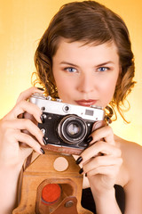 glamorous girl holding a camera