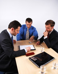 	Three businessmen handling negotiations.