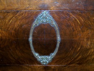 Decorative Oval Carved Frame on Rich, Dark Wood 