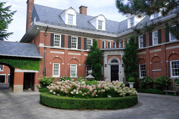 Large house with hydrangea in circular driveway