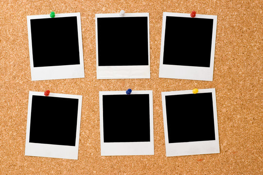 polaroid photos on a corkboard