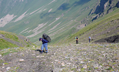 Three people making their descent up