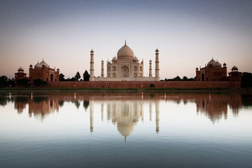 Taj Mahal reflected in river at twilight