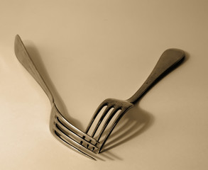 Two old forks in brown lighting