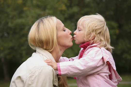 girl and mother kiss