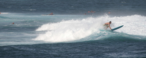 Panorama of a surfer in the ocean waves of Maui, Hawaii