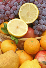 Fototapeta na wymiar Lemon with pear, grape,tangerine and other fruit