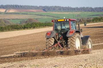 Obraz premium Tractor breaking up the soil