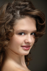 Beautiful teen girl with brown curly hair 