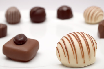 Ring of chocolates – focus on nearest white chocolate