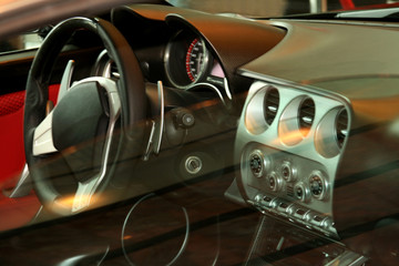 Fototapeta premium looking at a car dash and steering wheel through the passenger w