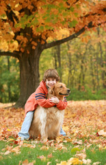 Boy Hugging Golden Retriever