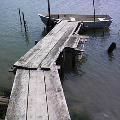 Boat at wood plank jetty