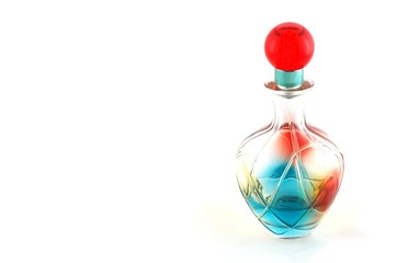 colored bottle of perfume over white background