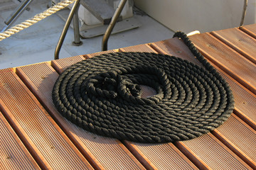 Coiled line of boat rope on dock
