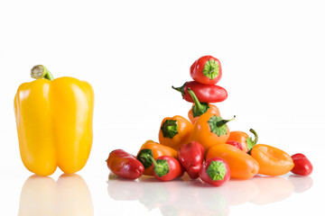 Fototapeta na wymiar Bell pepper next to a small peppers