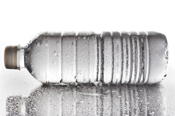 Wet water bottle on a reflective tabletop