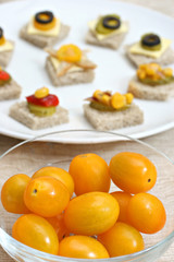 Yellow cherry tomato bread canapés in the background