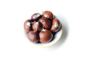 Chestnut in a little soup plate isolated on white background