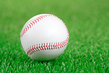 Baseball ball on a green grass background