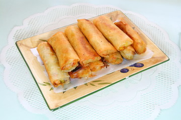 deep fried springrolls served in a rectangular dish
