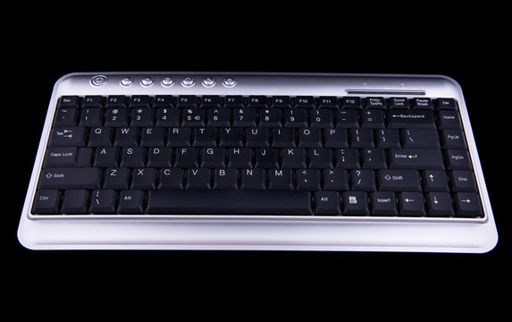 Computer keyboard on black background