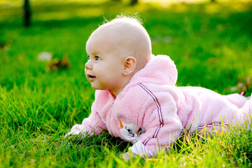 Baby lying on grass