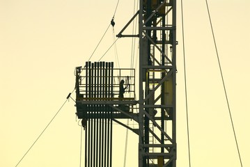 Roughneck on pipe rack of drilling rig