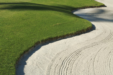 Abstract of bunker and putting green.
