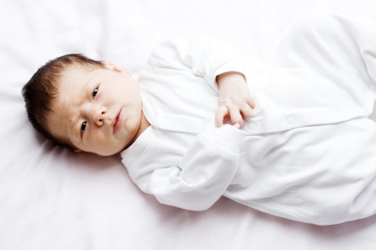 Baby girl in white bed