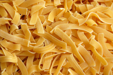 Fresh biological tagliatelle pasta background