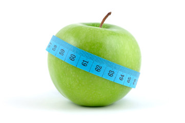 Green apple with measuring tape