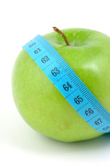 Green apple with measuring tape