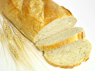 Sliced bread and wheat spikes