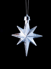 silver star on black background