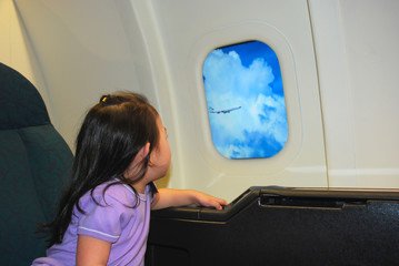 girl looking out of airplane