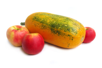 Yellow summer squash and red apples on white background