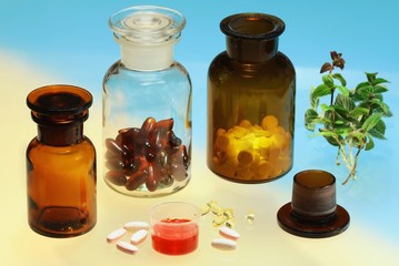 Glass full of  pharmaceuticals on color background